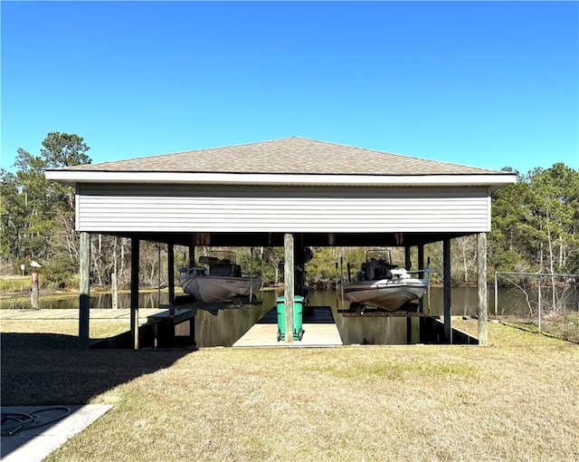 exterior space featuring boat lift, a water view, fence, a carport, and a dock