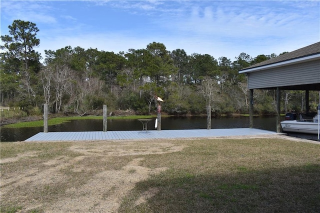 dock area with a water view and a yard