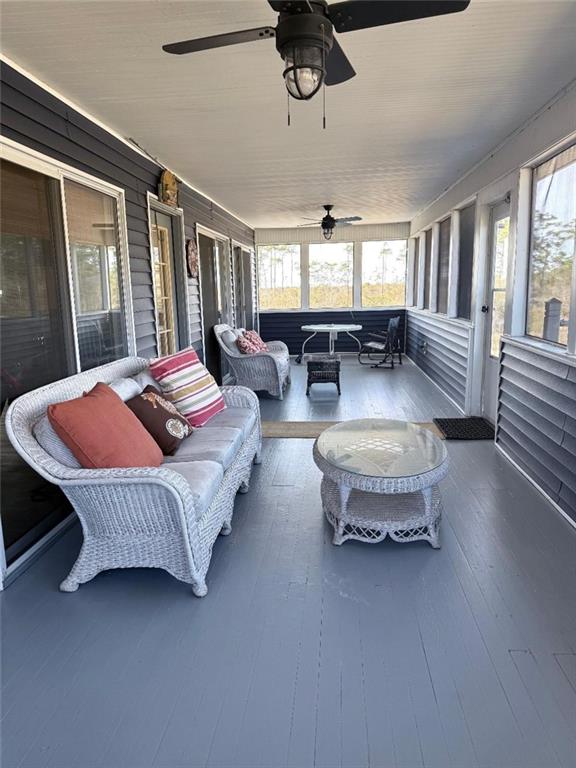 sunroom featuring a ceiling fan