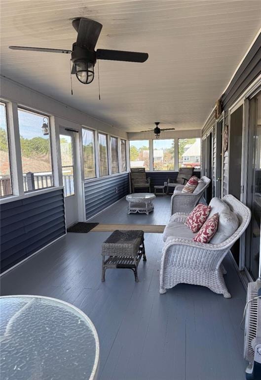 sunroom / solarium with a ceiling fan