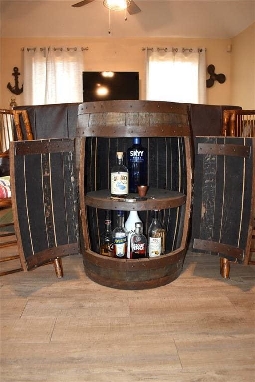 bar featuring ceiling fan and wood finished floors