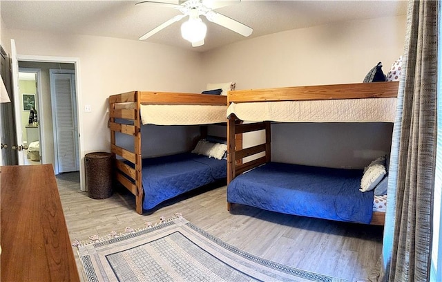 bedroom with a ceiling fan and wood finished floors