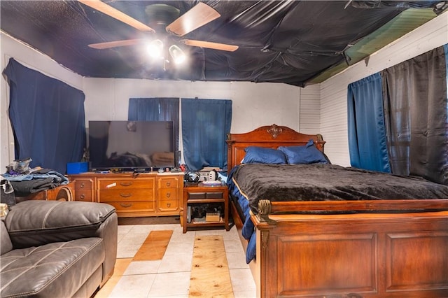 tiled bedroom featuring ceiling fan