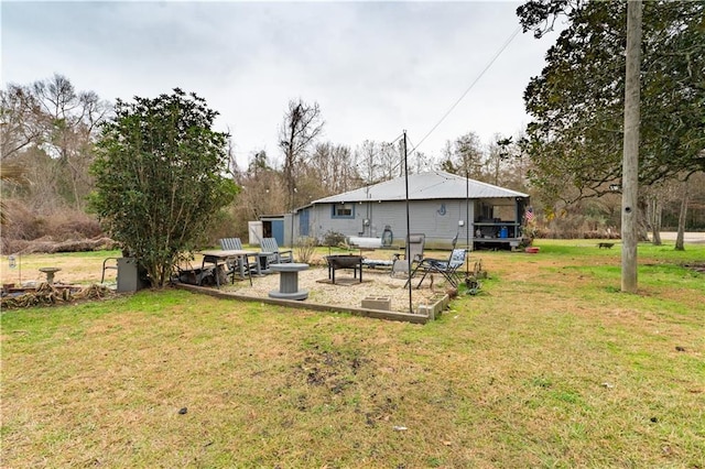 rear view of property with a yard and a patio