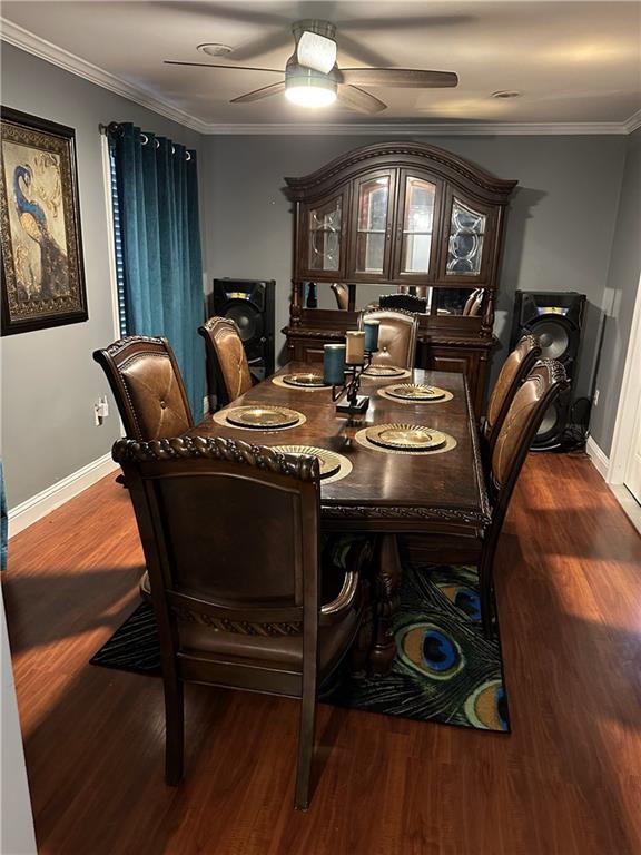 dining room with crown molding, ceiling fan, and dark hardwood / wood-style flooring