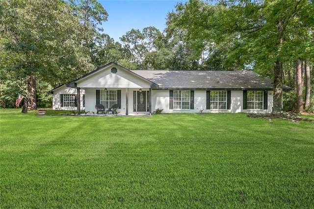 back of property featuring a lawn and covered porch