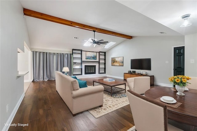 living room featuring ceiling fan, dark hardwood / wood-style floors, and vaulted ceiling with beams