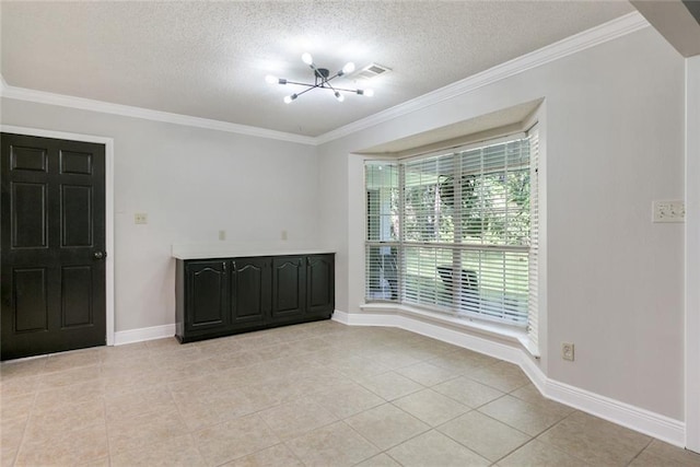 tiled spare room featuring ornamental molding, a chandelier, and a textured ceiling