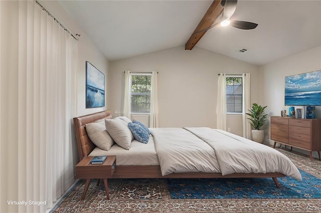 bedroom featuring ceiling fan, lofted ceiling with beams, and multiple windows