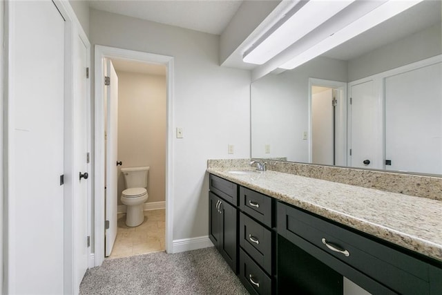 bathroom with vanity, tile patterned floors, and toilet