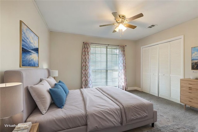 bedroom with ceiling fan, carpet floors, and a closet