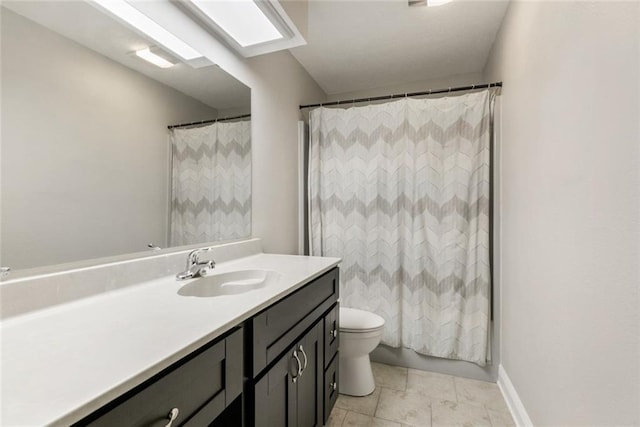 bathroom featuring vanity, toilet, and tile patterned flooring