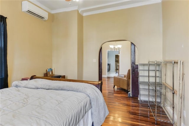 bedroom featuring hardwood / wood-style flooring, ornamental molding, and a wall mounted air conditioner