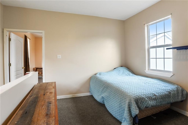 bedroom with dark colored carpet