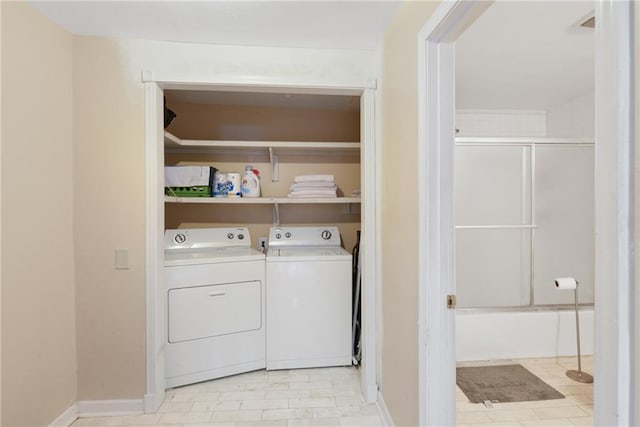 clothes washing area with washing machine and clothes dryer