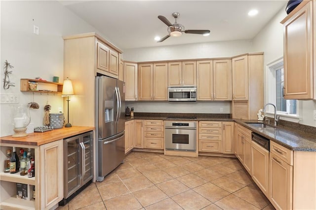 kitchen featuring wine cooler, sink, light brown cabinets, and appliances with stainless steel finishes