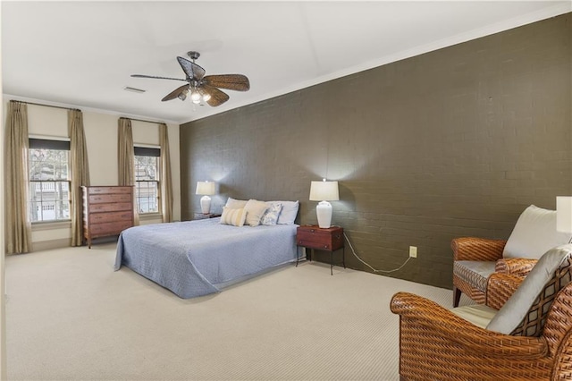 bedroom with crown molding, brick wall, carpet flooring, and ceiling fan