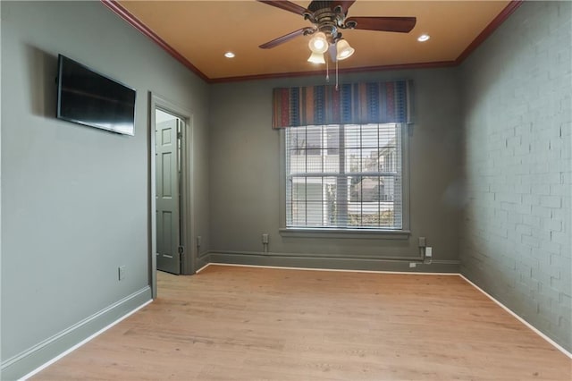 spare room featuring ceiling fan, ornamental molding, and light wood-type flooring