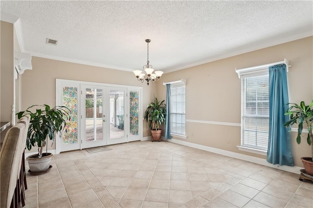 dining room featuring light tile patterned flooring, a wealth of natural light, an inviting chandelier, and french doors