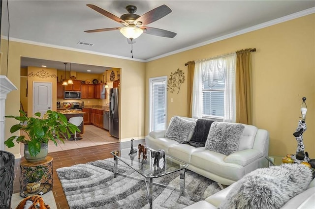 living room with ceiling fan and ornamental molding