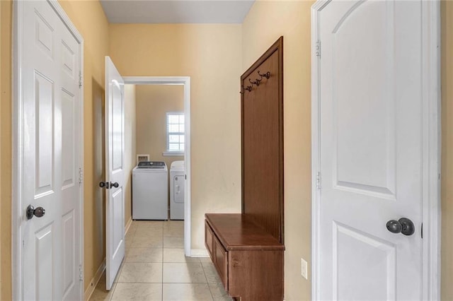 mudroom featuring washing machine and dryer and light tile patterned floors