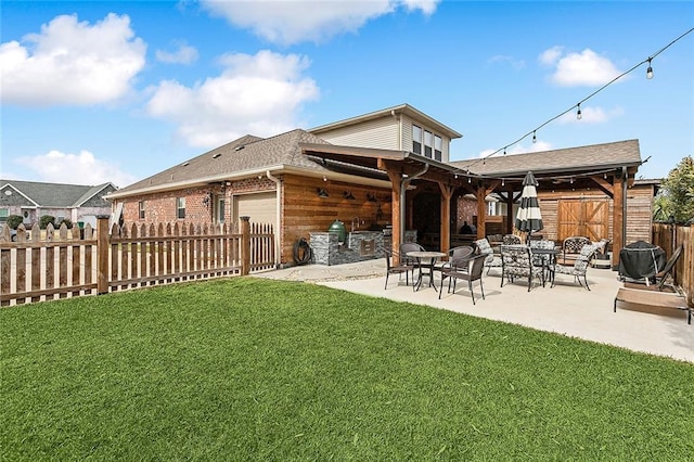 rear view of house with a patio area and a lawn