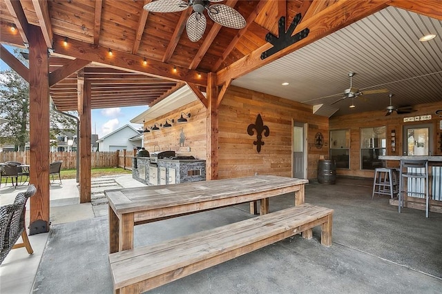 view of patio with an outdoor bar and ceiling fan