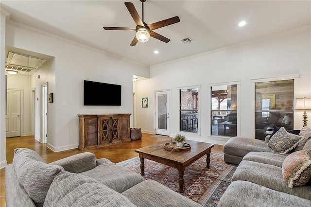 living room with crown molding and ceiling fan