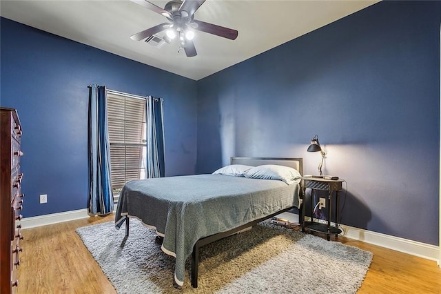 bedroom with wood-type flooring and ceiling fan