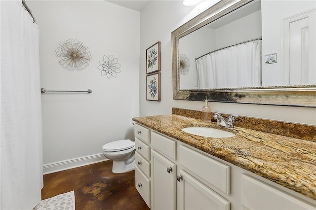 bathroom with concrete flooring, vanity, and toilet