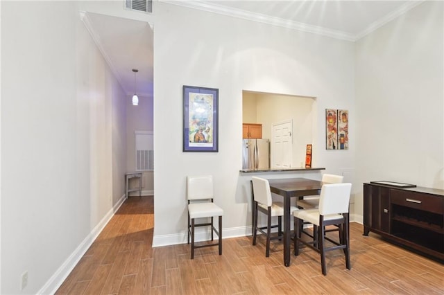 dining area featuring ornamental molding