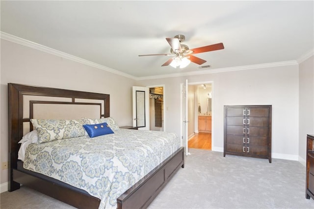 carpeted bedroom with ensuite bath, ornamental molding, a closet, and ceiling fan