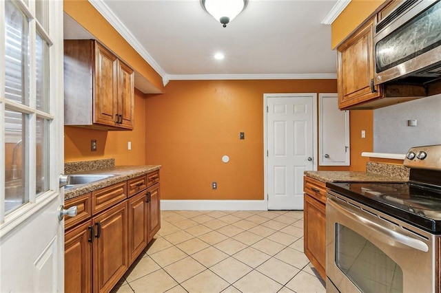 kitchen featuring crown molding, stainless steel appliances, light tile patterned flooring, and sink