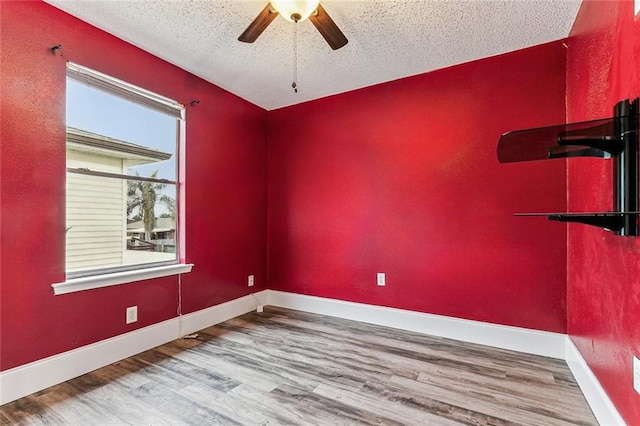 unfurnished room featuring hardwood / wood-style floors, a textured ceiling, and ceiling fan