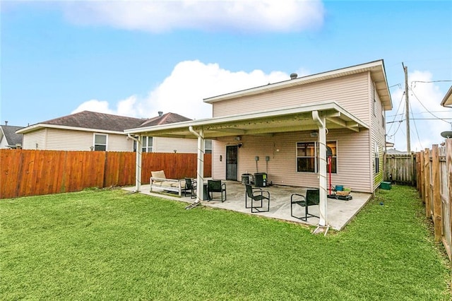 rear view of house featuring a patio area and a lawn