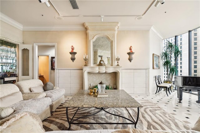 living room with crown molding and track lighting