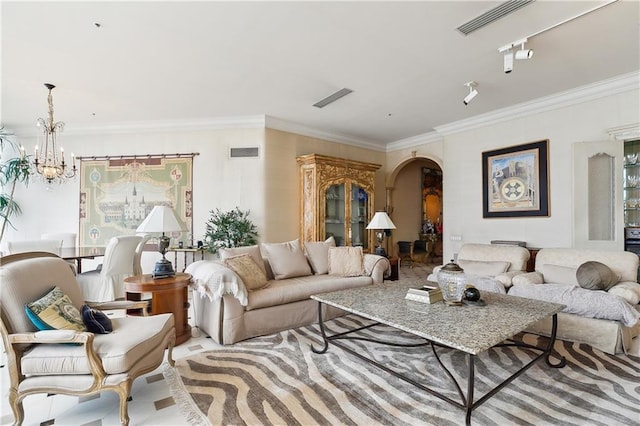 living room featuring crown molding and a notable chandelier