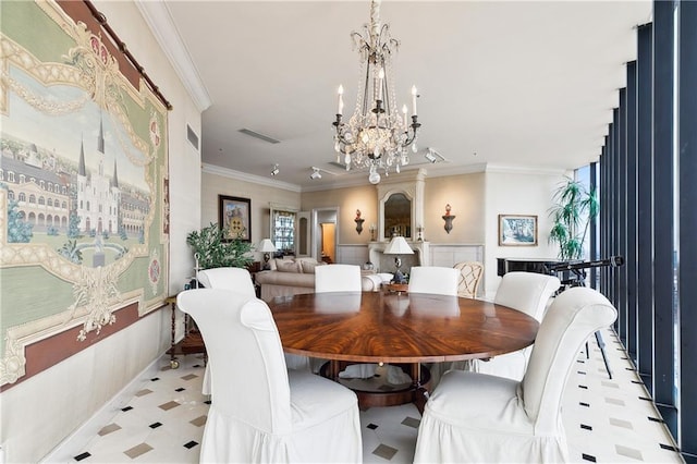 dining room with a notable chandelier, crown molding, and a wealth of natural light