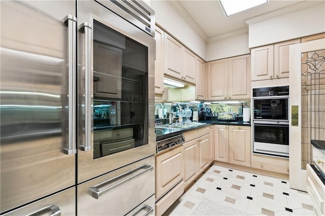 kitchen featuring sink, crown molding, high end fridge, double wall oven, and light brown cabinetry