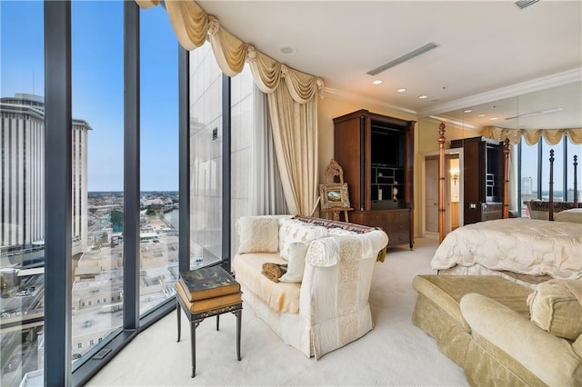 carpeted bedroom with multiple windows, ornamental molding, and a wall of windows