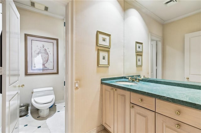 bathroom featuring tile patterned floors, ornamental molding, toilet, and vanity