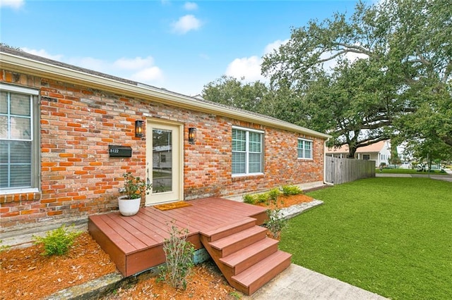 rear view of house featuring a yard