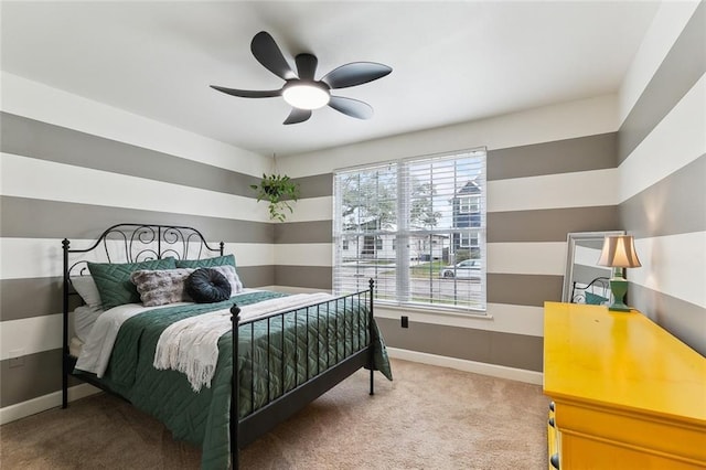 bedroom featuring multiple windows, ceiling fan, and carpet