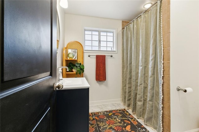 5122 Pratt Dr, New Orleans, LA 70122 - full bathroom featuring baseboards, marble look tile flooring, a shower with shower curtain, and vanity