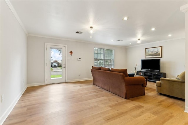 living room featuring crown molding and light wood-type flooring