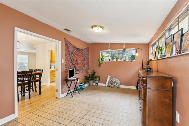 5122 Pratt Dr, New Orleans, LA 70122 - dining area featuring light tile patterned flooring, baseboards, and healthy amount of natural light