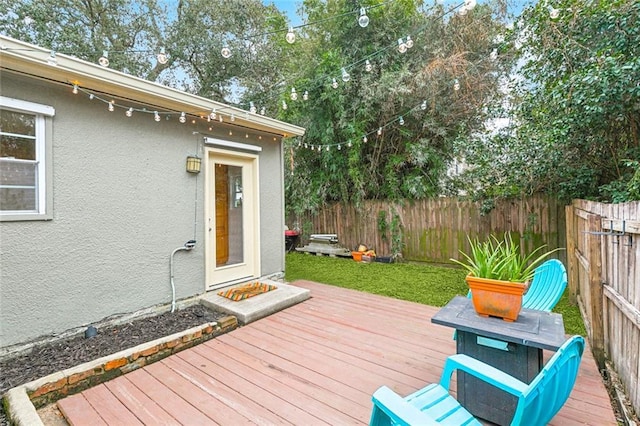 wooden deck featuring a lawn