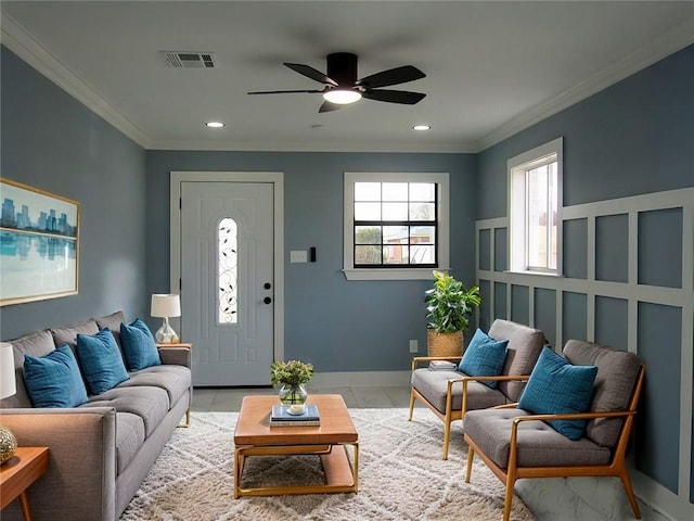 interior space with ceiling fan and ornamental molding