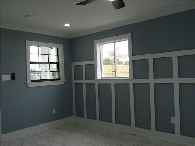 spare room featuring crown molding and ceiling fan