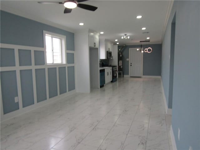 interior space with ceiling fan and ornamental molding